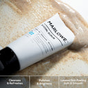 Three bottles of MARLOWE. exfoliating facial scrub with apricot seed and pumice, showing the product labels and textured scrub inside