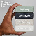 Set of four MARLOWE charcoal soap bars from the Discovery Set, featuring natural, handcrafted skincare with rich lather and cleansing properties.